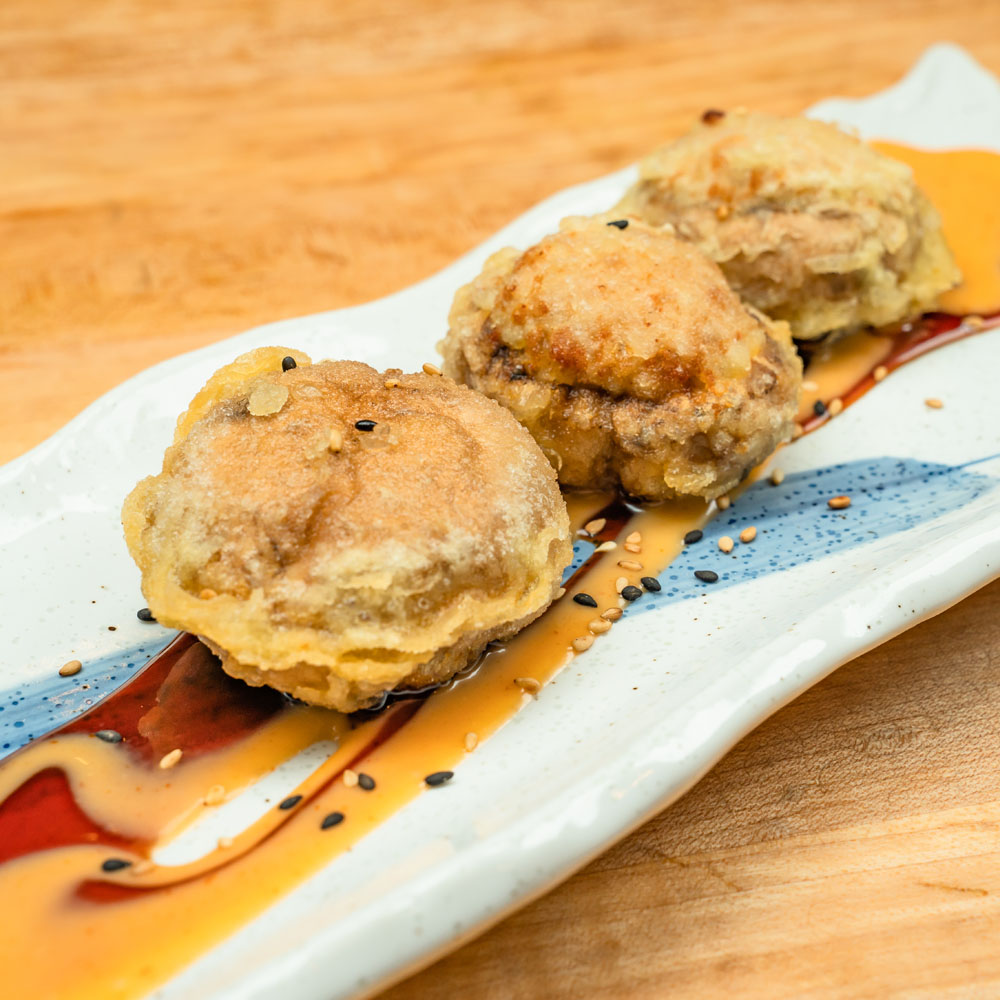 Atomic Bomb appetizer — deep-fried mushrooms stuffed with spicy tuna, drizzled with sauces.