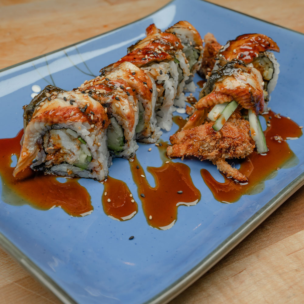 Champion Roll — sushi roll with soft shell crab, topped with barbecued eel and eel sauce.