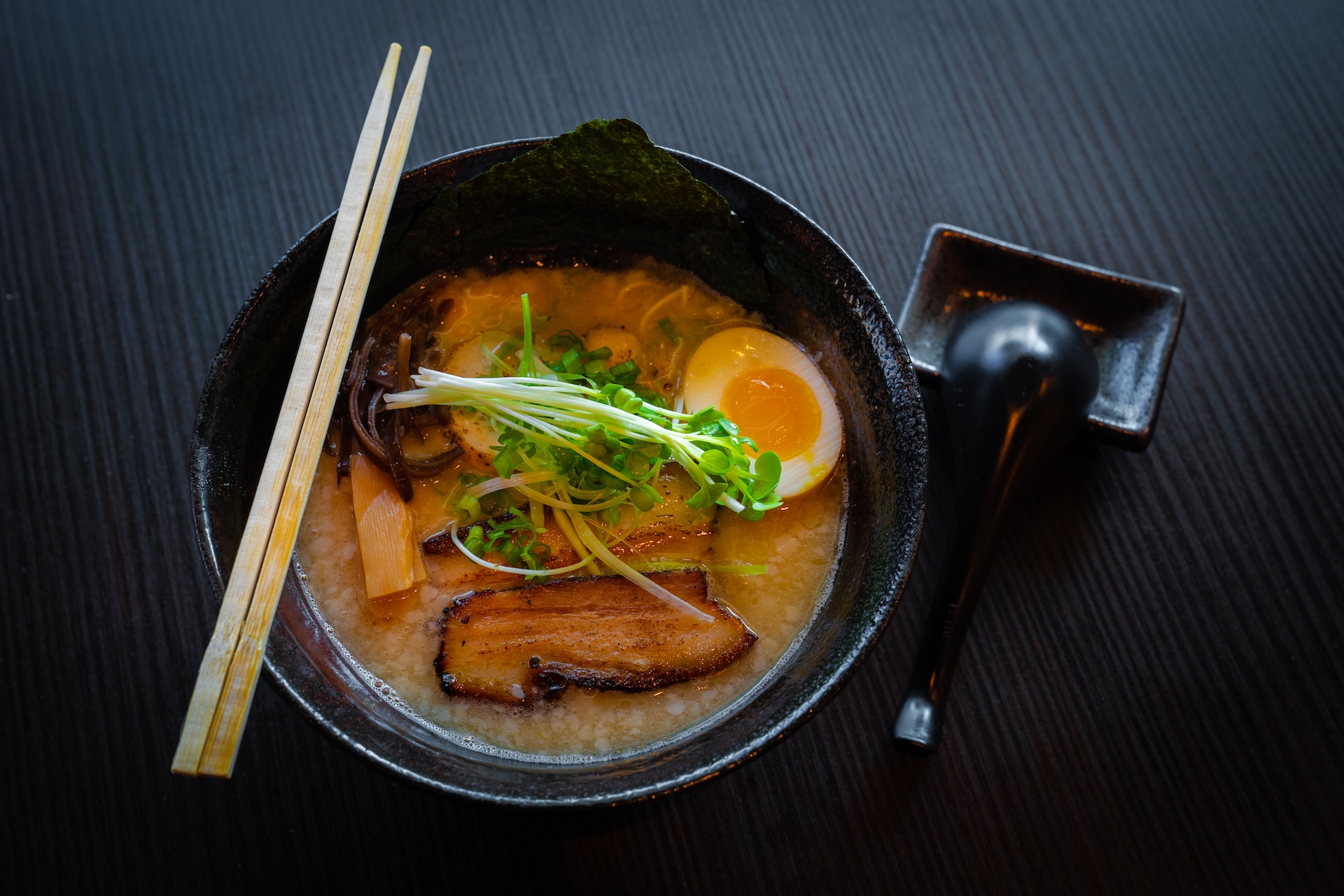 Misaka Tonkotsu ramen — noodles in a rich, creamy broth topped with pork belly, egg, and green onions.