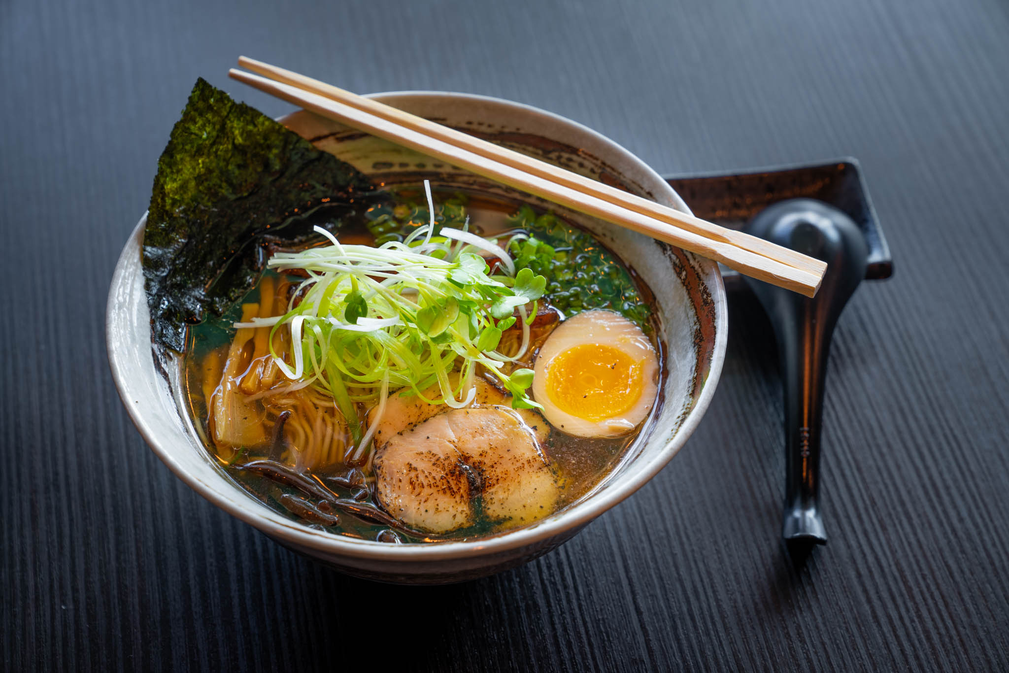 Shoyu Ramen — noodles in clear broth with pork belly, soft-boiled egg, and nori.