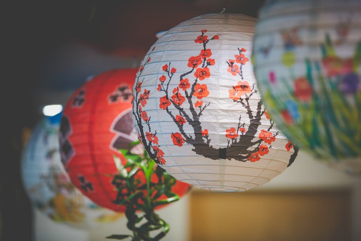 Paper lanterns hand-painted with cherry blossoms hanging in the dining room.